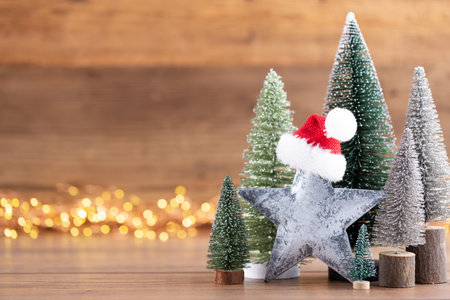 Colorful Christmas tree on wooden, bokeh background. Christmas holiday celebration concept. Greeting card.の写真素材
