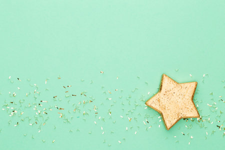 Festive pastel background. Christmas stars and shining glitter, confetti on pastel background. Christmas. Wedding. Birthday. Valentine's Day. Flat lay.の写真素材