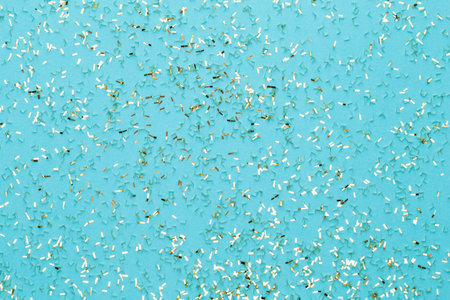 Festive pastel background. Christmas stars and shining glitter, confetti on pastel background....
