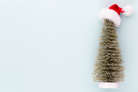 Christmas tree on pastel colored background. Christmas or New Year minimal concept.