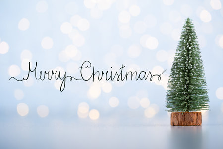 Merry christmas background design for greeting card on a blue bokeh background.の写真素材
