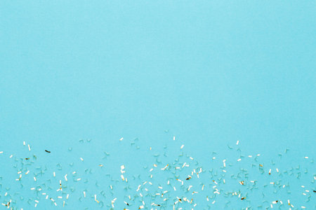 Festive pastel background. Christmas stars and shining glitter, confetti on pastel background....