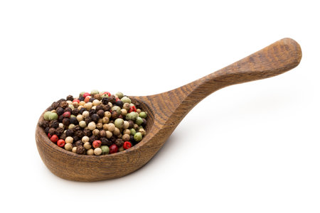 Pepper seed on spoon on white background.の写真素材