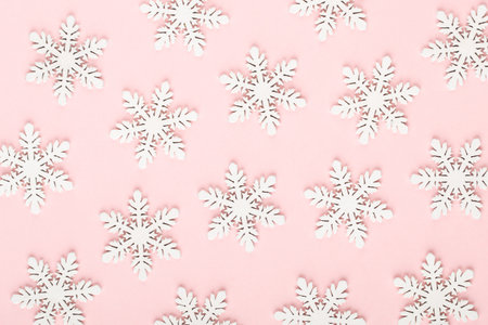 Christmas background. White snow decorations on a pink background.の写真素材