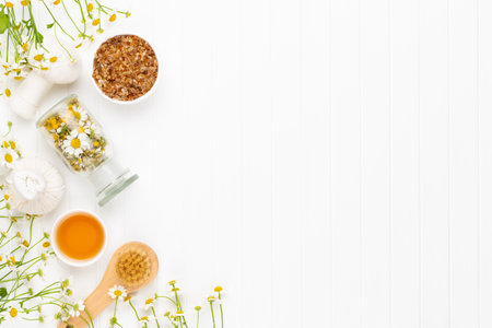Composition aromatherapy with natural cosmetics and chamomile flowers on light background.の写真素材