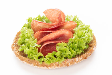 Sandwich with salami sausage on white background.の写真素材