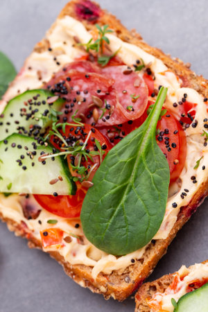 Sandwiches with cream cheese, vegetables and salami. Sandwiches with cucumber, radish, tomatoes,...