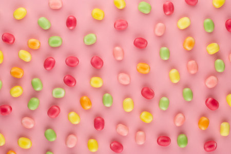 Small round candy-colored pastels on pastelの写真素材
