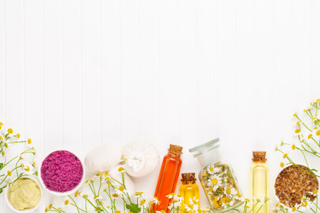 Composition aromatherapy with natural cosmetics and chamomile flowers on light background.の写真素材