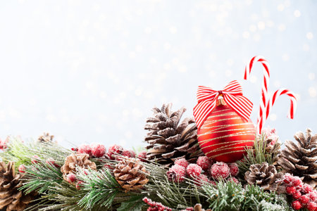 Christmas and New Year holidays bokeh background. Christmas Decoration Banner - Snowy Pine Cones On Fir Branch With Christmas Lights. Christmas bokeh background with snow fir tree. Top view with copy space for your text. の写真素材
