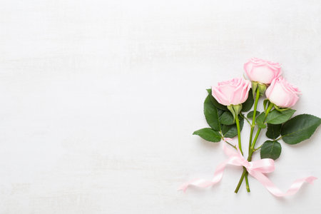 Spring greeting card, pastel color rose on the gray background.  Flower greeting card. Flat lay.の写真素材