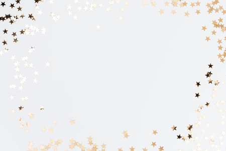 Festive pastel background. Christmas stars and shining glitter, confetti on pastel background. Christmas background, Flat lay.の写真素材