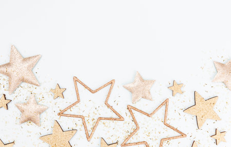 Festive pastel background. Christmas stars and shining glitter, confetti on pastel background. Christmas background, Flat lay.の写真素材