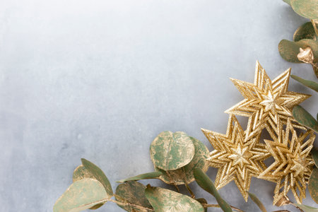 Festive pastel background. Christmas stars and shining glitter, confetti on pastel background. Christmas background, Flat lay.の写真素材