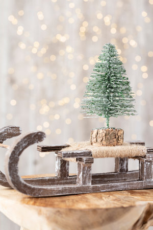 Christmas tree on wooden, bokeh background. Christmas holiday celebration concept. Greeting card.の写真素材