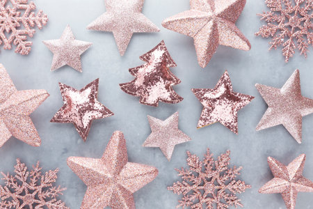 Festive pastel background. Christmas stars and shining glitter, confetti on pastel background. Christmas background, Flat lay.の写真素材