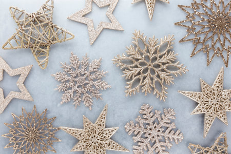 Festive pastel background. Christmas stars and shining glitter, confetti on pastel background. Christmas background, Flat lay.の写真素材