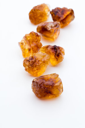 Brown caramelized lump cane sugar cube isolated on white background.の写真素材