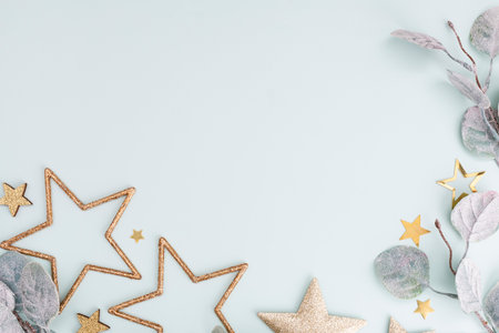 Festive pastel background. Christmas stars and shining glitter, confetti on pastel background. Christmas background, Flat lay.の写真素材
