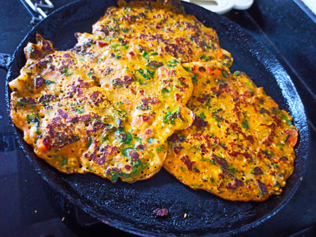Pancakes with meat, vegetables and spices in a frying panの写真素材