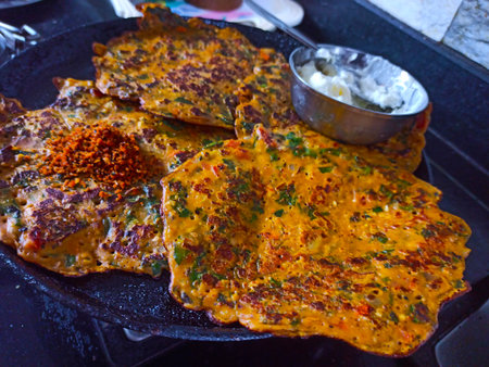 Pancakes with meat and vegetables on the grill in the restaurantの写真素材