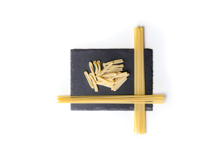 Italian pasta isolated on a black plateの写真素材