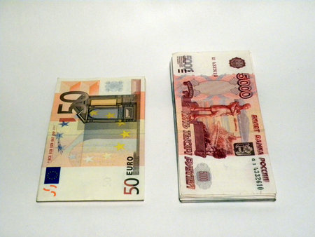 Two bundles of money - of euro and of roubles, roubles are moreの写真素材