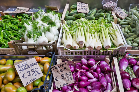 Exhibition of seasonal vegetables in boxes on the stalls at the open street market in the historic center of bolognaのeditorial素材