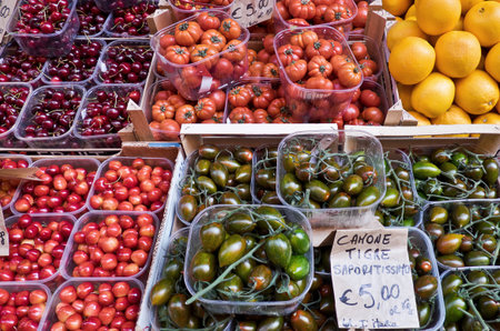 Exhibition of seasonal fruit and vegetables in boxes on the stalls at the open street market in the historic center of bolognaのeditorial素材