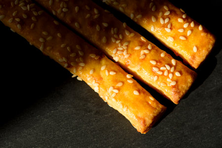 Traditional Italian snack, bread ,grissini on black table, top view,の写真素材