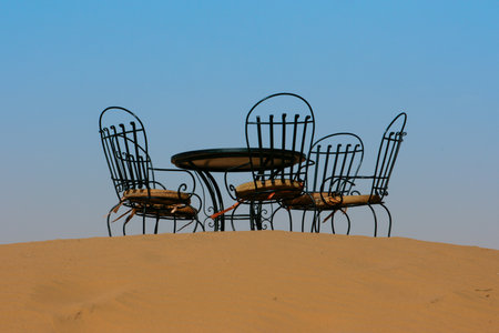 Tea table with chairs in sahara desert, Moroccoの写真素材