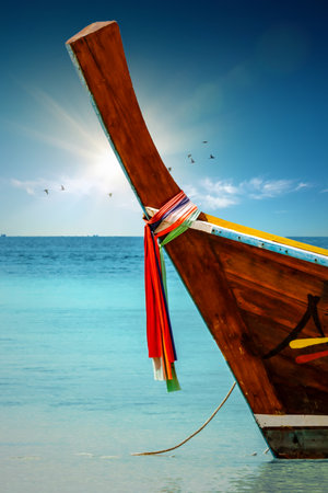 Scenic view of traditional thai longtail boats on the beach of Ko Ngai, Koh Lanta, Thailand.