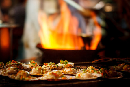 Selective focus picture of some Grilled scallops sold at a street market stall with a pan covered...