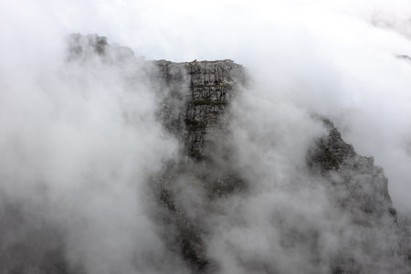 Scenic view of the clouds rolling over Table Mountain in Cape Town, Southafica. This fenomenon is...