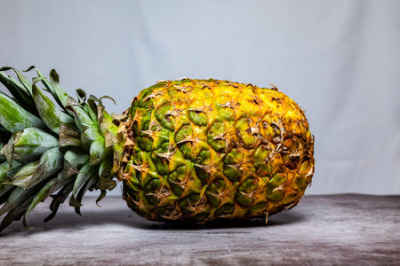 Pineapple on the wooden table with white background, stock photoの写真素材