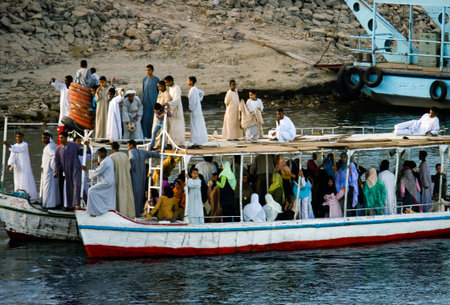 Aswan, Egypt - December 17, 2005: A boat full of local people on the Nile riverのeditorial素材