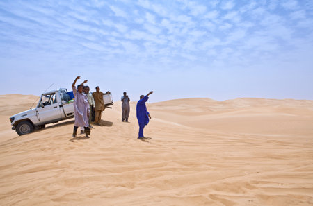 Sahara Desert, Libya - April 26, 2009: Young local man near a car in the Ubari dunes areaのeditorial素材