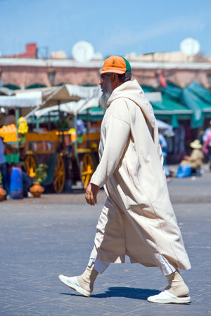 Marrakech, Morocco - March 26, 2006: Local people walking in the famous square Jemaa El Fnaのeditorial素材
