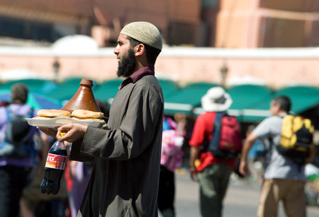 Marrakech, Morocco - March 26, 2006: A local vendor in the famous Jemaa el Fna square.のeditorial素材