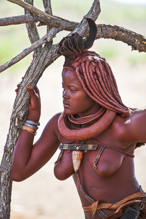 Kaokoland, Namibia - December 9, 2009: A young local woman in a Himba village