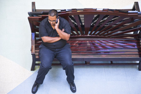Durban, South Africa - March 10, 2010: Suncoast, a young man phoning in the Entrateinmet World and Casino, traditional meeting point of indian comunityのeditorial素材