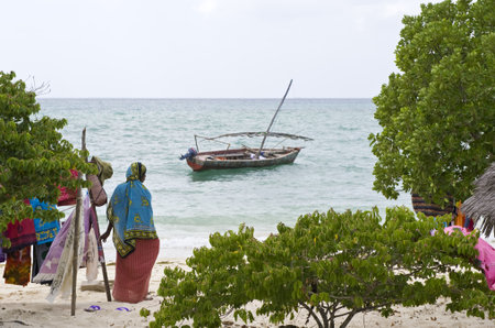 Zanzibar, Tanzania - February 27, 2008:  Western coast,  a woman in an handicraft shop on the beach of Manai bayのeditorial素材