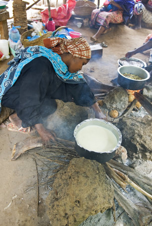 Zanzibar, Tanzania - February 28, 2008: Native woman cook the food in a village of the interlandのeditorial素材