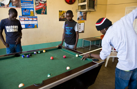Aruscha, Tanzania - September 2, 2008: Young local people playing in a tavern of the general marketのeditorial素材
