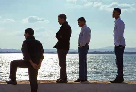 Hammamet, Tunisia - May 6, 2007:  Local young people on the seafront at sunsetのeditorial素材