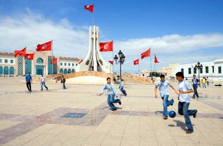 Tunis, Tunisia - May 4, 2010: Boys playing football in the Town Hall squareのeditorial素材