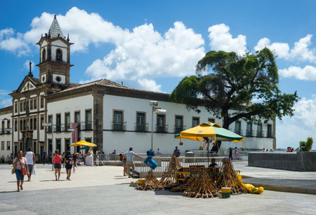 Salvador, Brazil - September 12, 2013: Praca Da Se, a vendor of musical instruments and the Misericordia church in the backgroundのeditorial素材