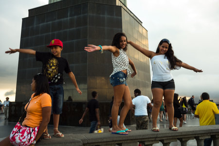 Rio De Janeiro, Brazil  - September 7, 2013: Tourists  posing for photograph taken under the Christ statue on Corcovadoのeditorial素材