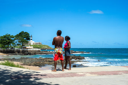 Salvador, Brazil - September 11, 2013: Barra district, a local couple looking towards the Forte do Farol lighthouseのeditorial素材