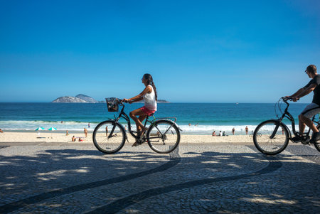 Rio De Janeiro, Brazil  - September 9, 2013: A couple in bycicle on the Ipanema beachのeditorial素材